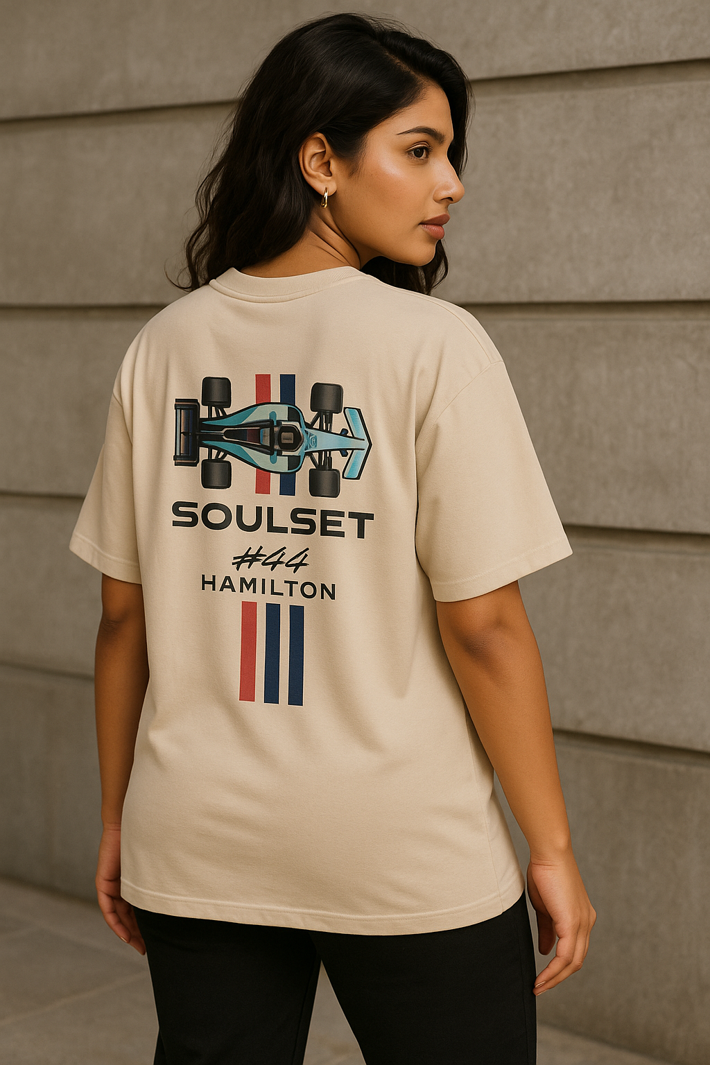 Woman wearing oversized beige F1-inspired SoulSet t-shirt with #44 graphic at a racetrack – stylish motorsport streetwear by SoulSet.Store