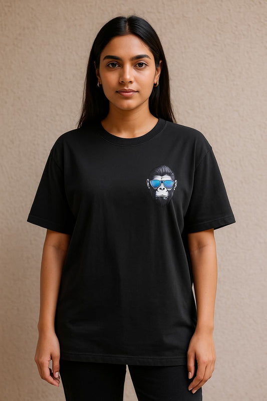 Person wearing a black t-shirt with a graphic design on a beige background