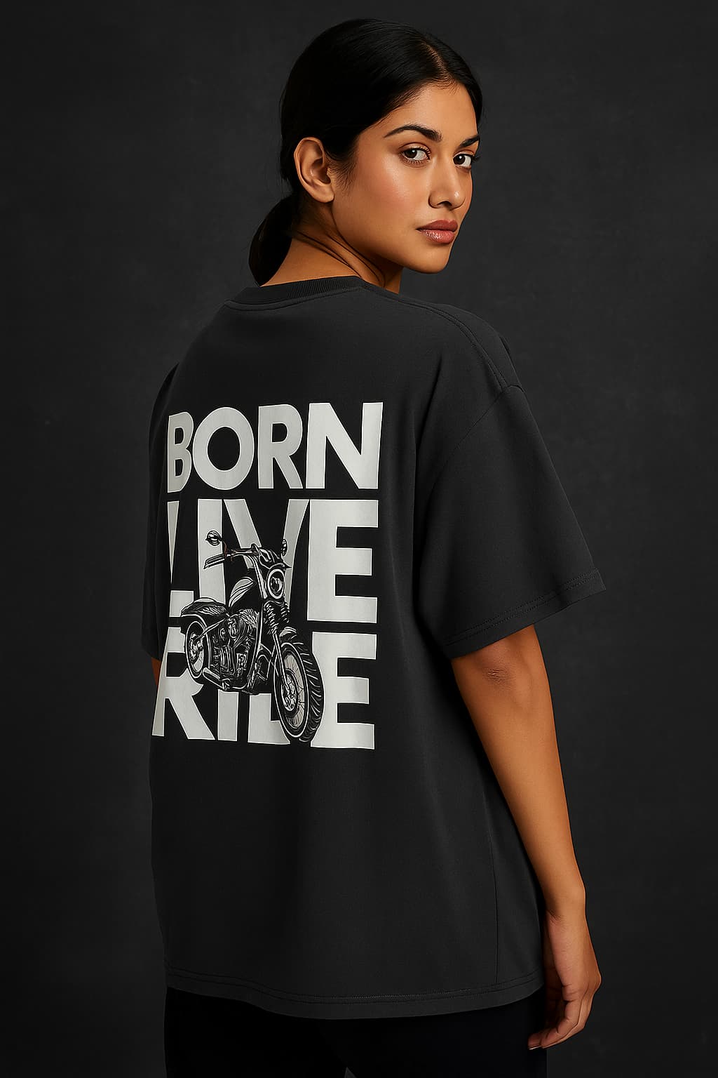 Person wearing a black t-shirt with 'Born to Live, Ride' text and motorcycle graphic on the back against a dark background.