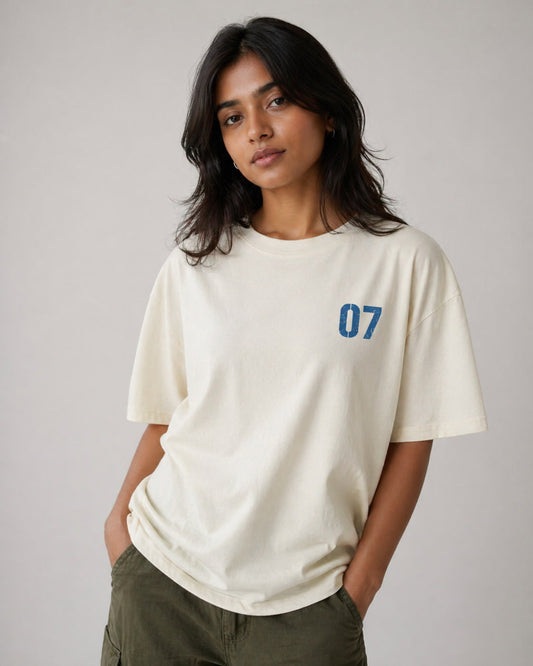 Person wearing a white t-shirt with the number 07 on a plain background