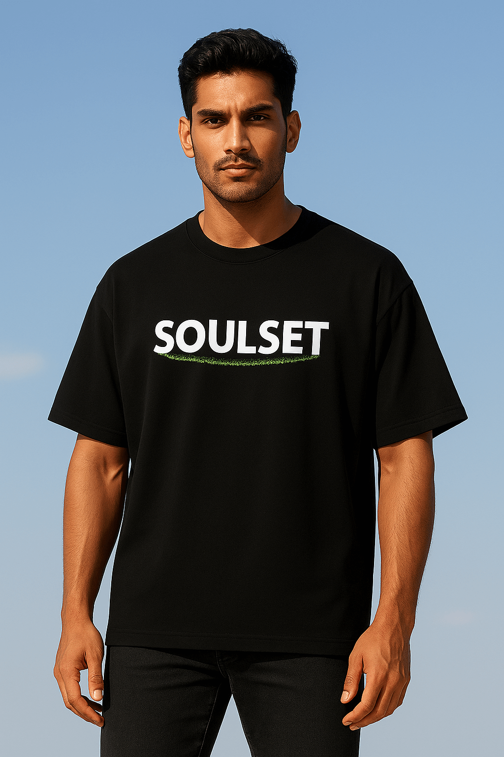 Indian male model wearing black oversized SoulSet T-shirt with bold white and green logo, standing confidently in a stylish modern pose – premium streetwear fashion for men