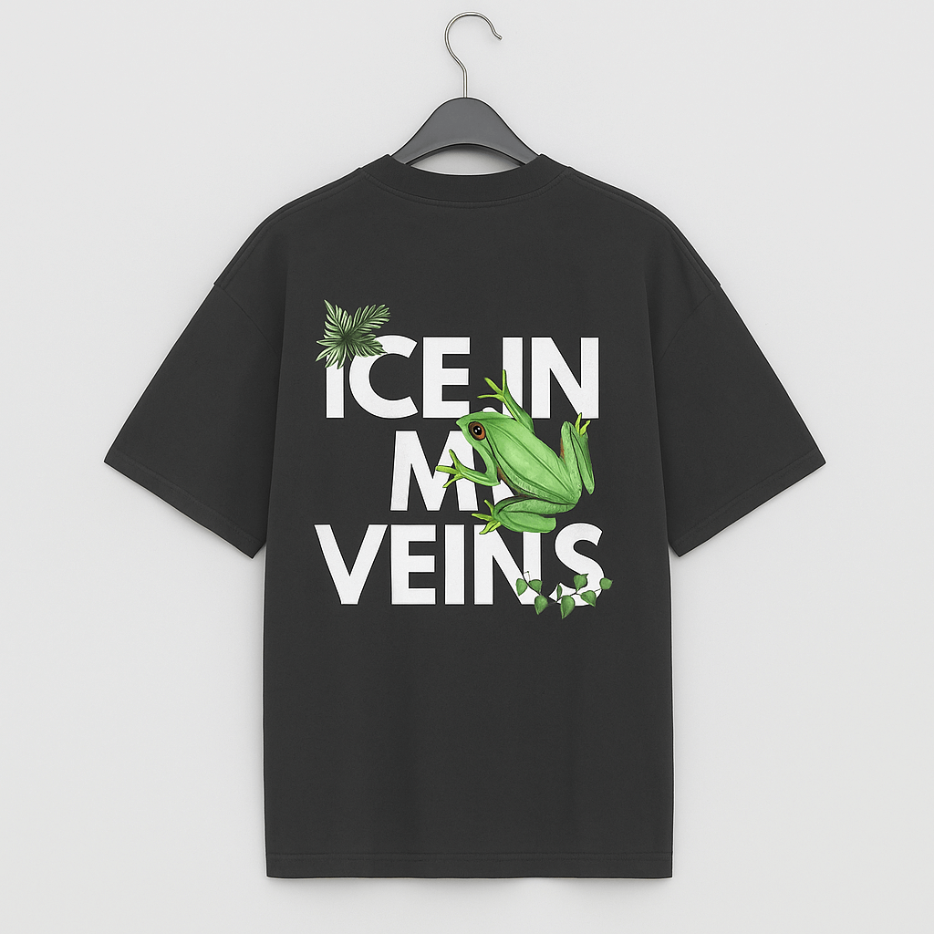 Back view of black oversized T-shirt with bold white text "ICE IN MY VEINS" and green frog with tropical leaves, streetwear style.