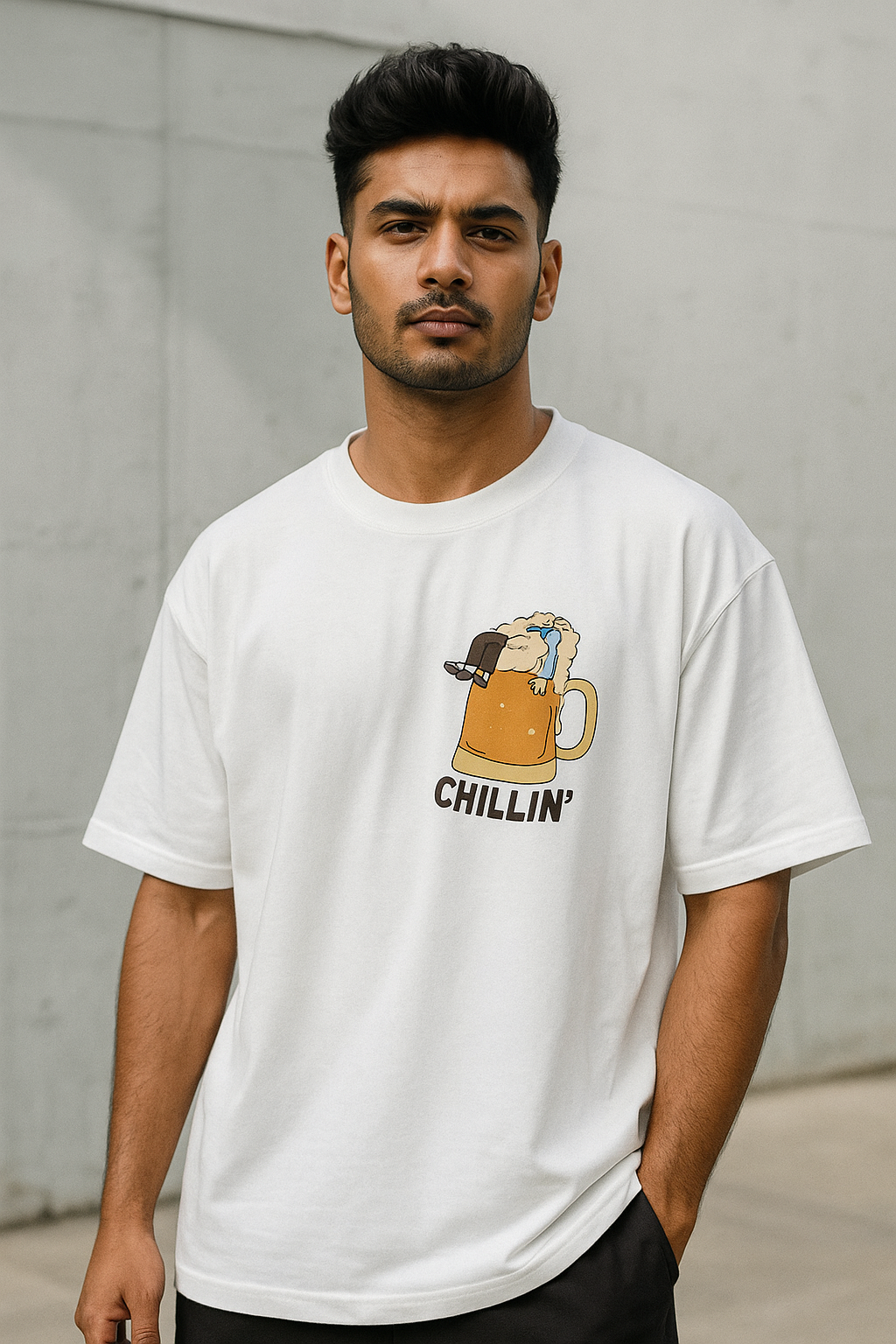 ndian male model wearing SoulSet white oversized graphic tee featuring CHILLIN' beer mug design – trendy streetwear look for Gen Z and millennial fashion.