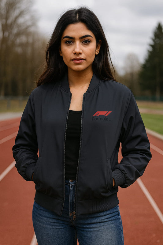 Woman wearing a black bomber jacket with Formula 1 logo on a track
