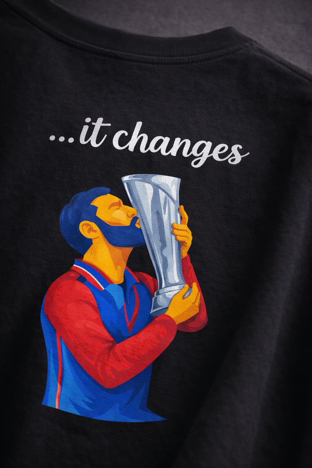Black sweatshirt with graphic of a person holding a trophy and text 'it changes' on a dark background
