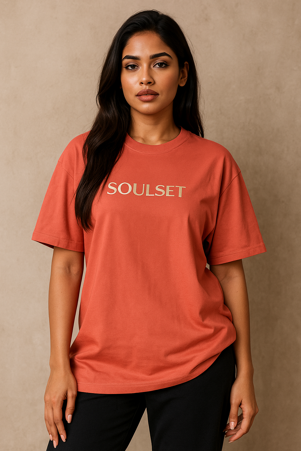 Woman wearing a red 'SOUSET' t-shirt against a beige background