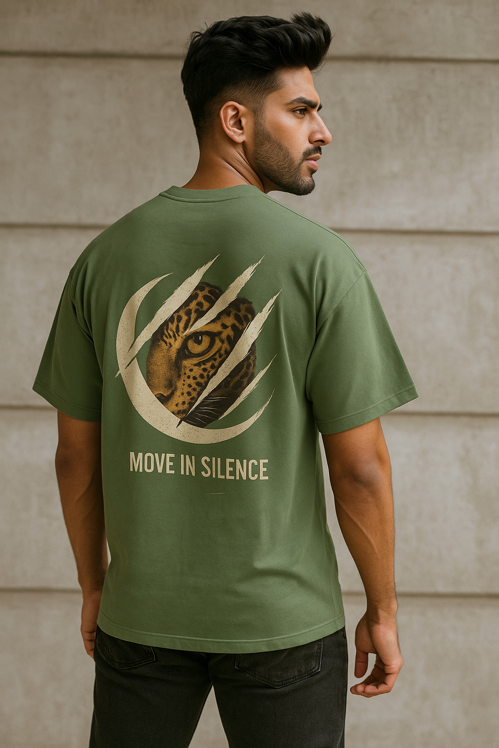 Man wearing a green t-shirt with a leopard design and text 'Move in Silence' on the back.