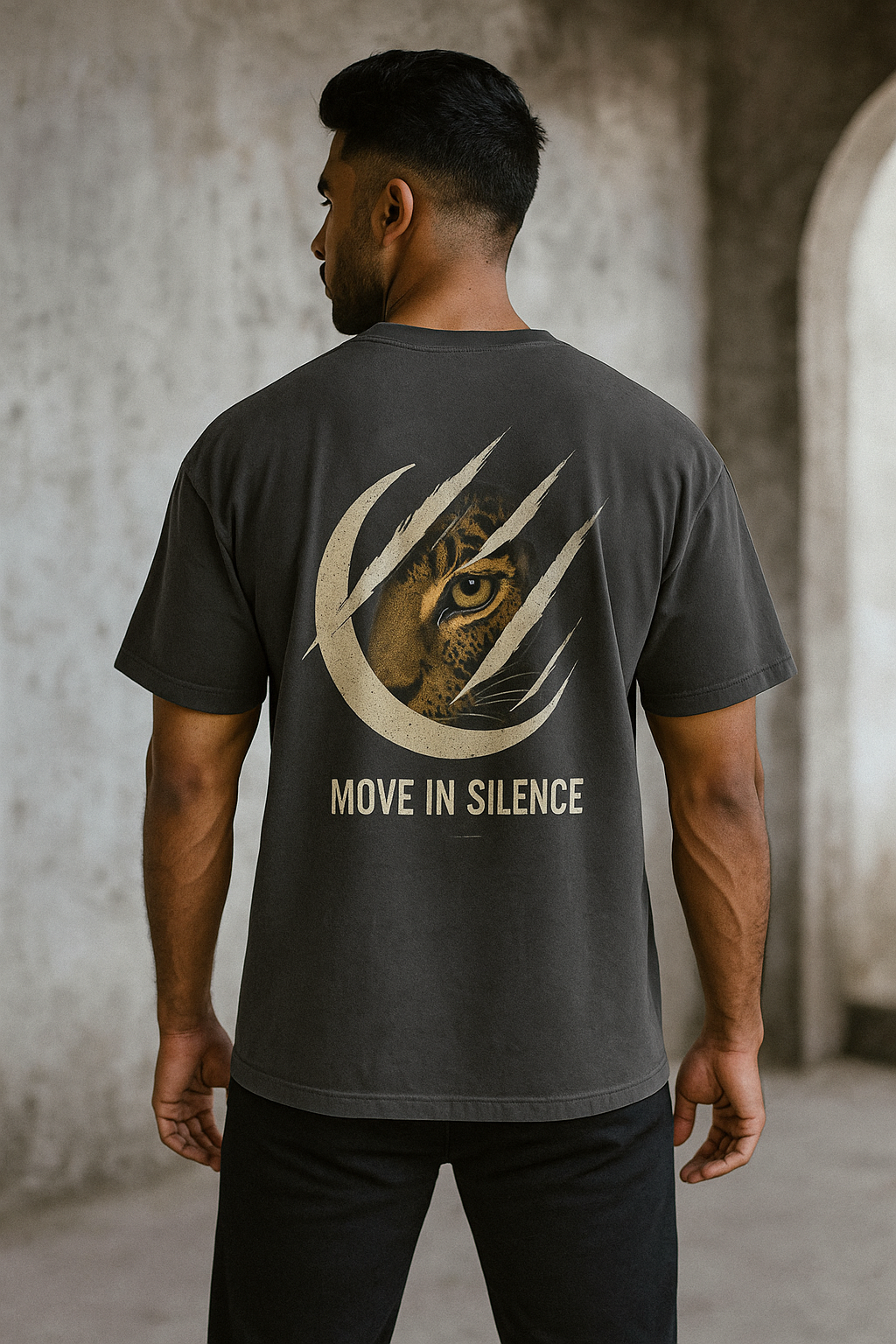 Oversized unisex t-shirt featuring a majestic owl with glowing eyes perched on a crescent moon, surrounded by sacred geometry and stardust detailing on the front. The back showcases an owl in flight fading into mist, with mandala feather rings and the phrase ‘Wisdom Sees All’ above.