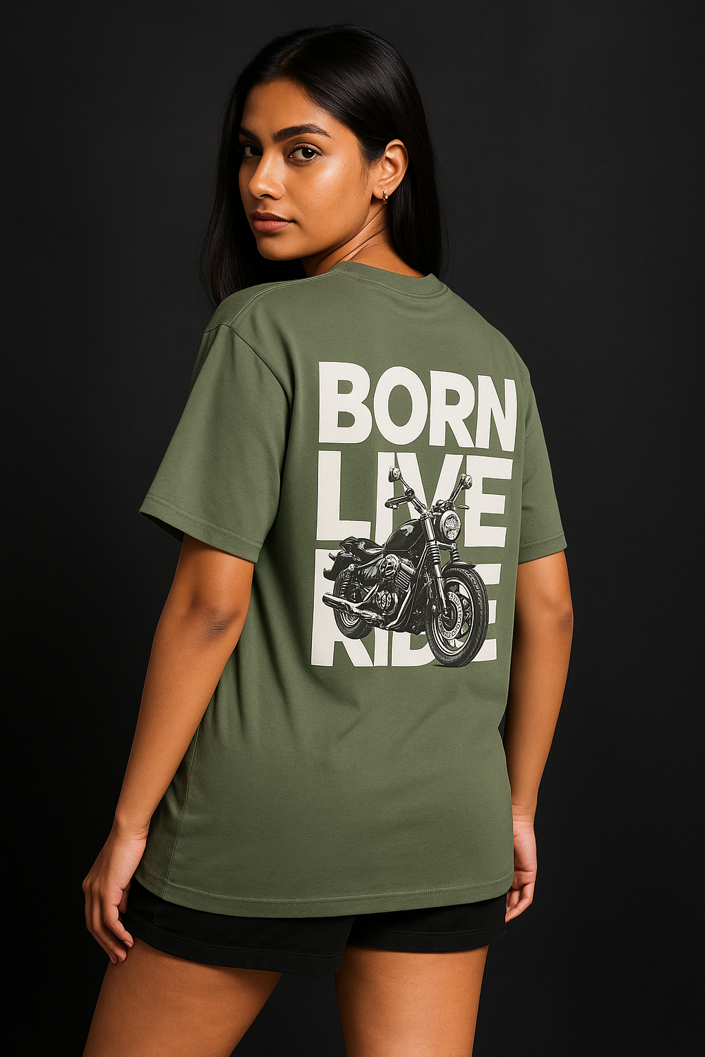 Person wearing a green t-shirt with a motorcycle graphic and text on the back against a black background
