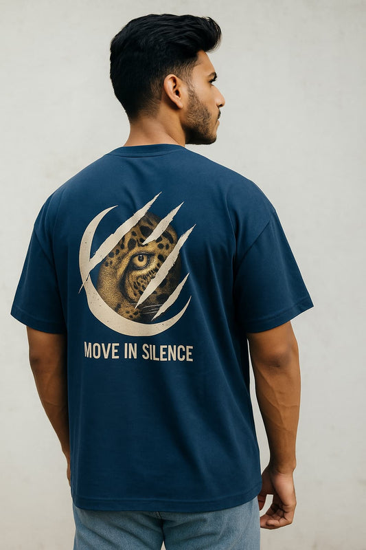 Man wearing a navy blue t-shirt with a leopard design and 'Move in Silence' text on the back.