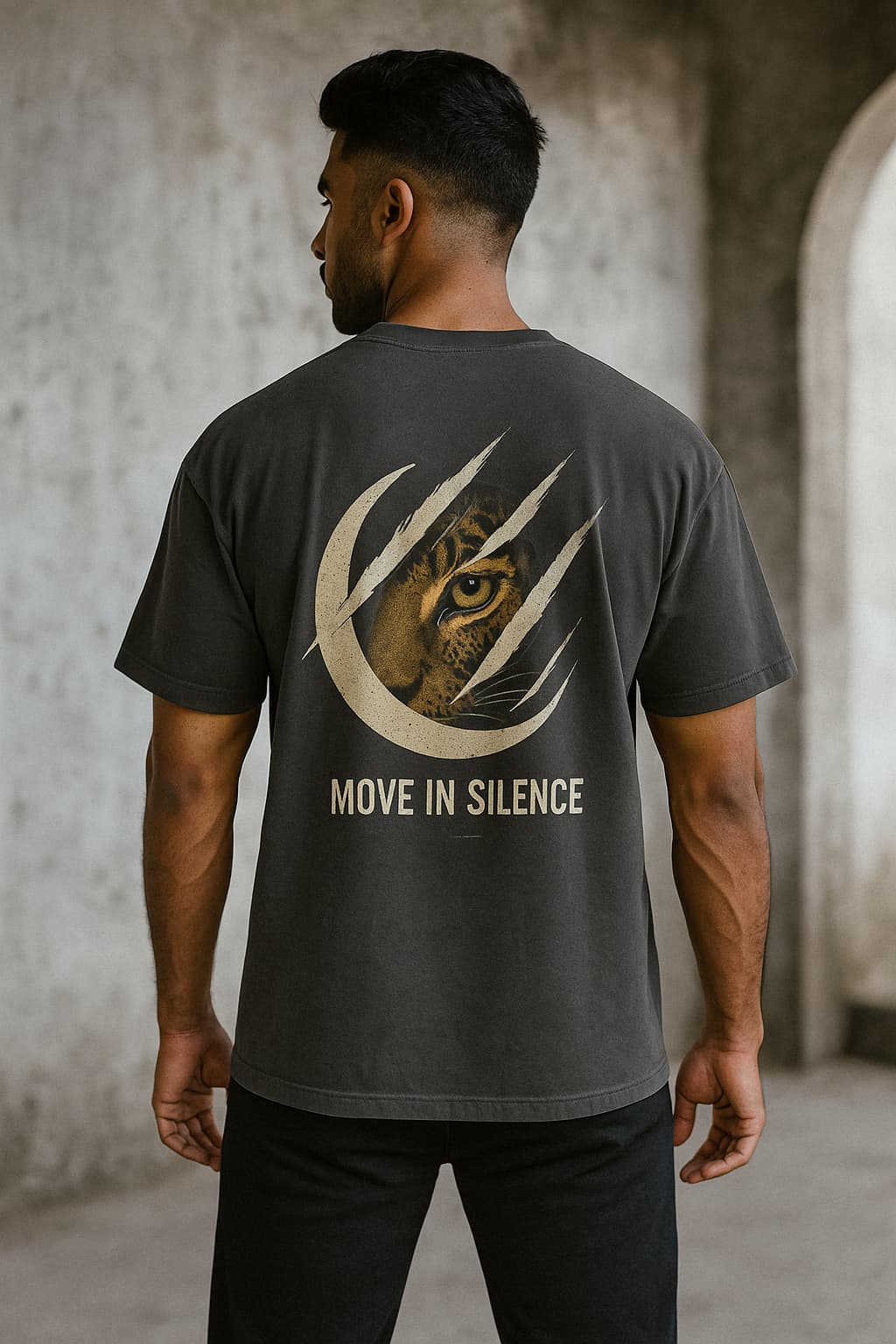 Man wearing a black t-shirt with a tiger design and 'Move in Silence' text on the back.