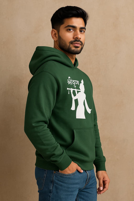 Man wearing a green hoodie with a white logo against a beige background