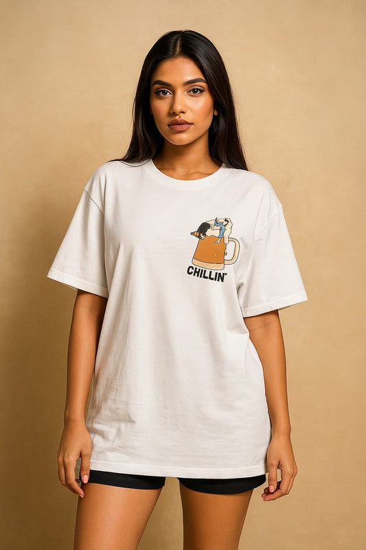Woman wearing a white t-shirt with a graphic design on a beige background