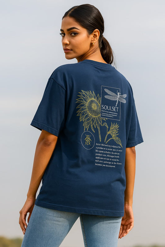 Woman wearing a navy blue t-shirt with nature-themed designs and text.