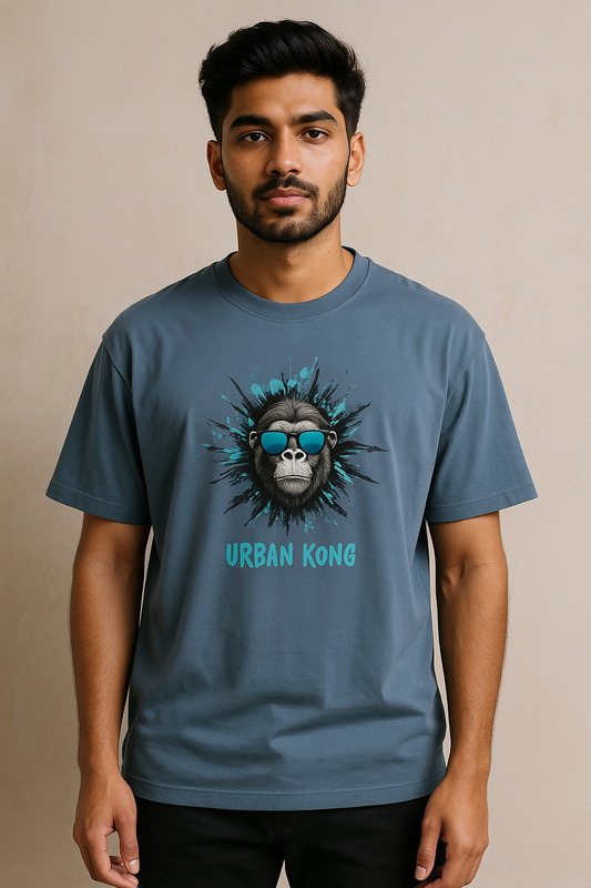 Man wearing a blue t-shirt with 'Urban Kong' design on a beige background