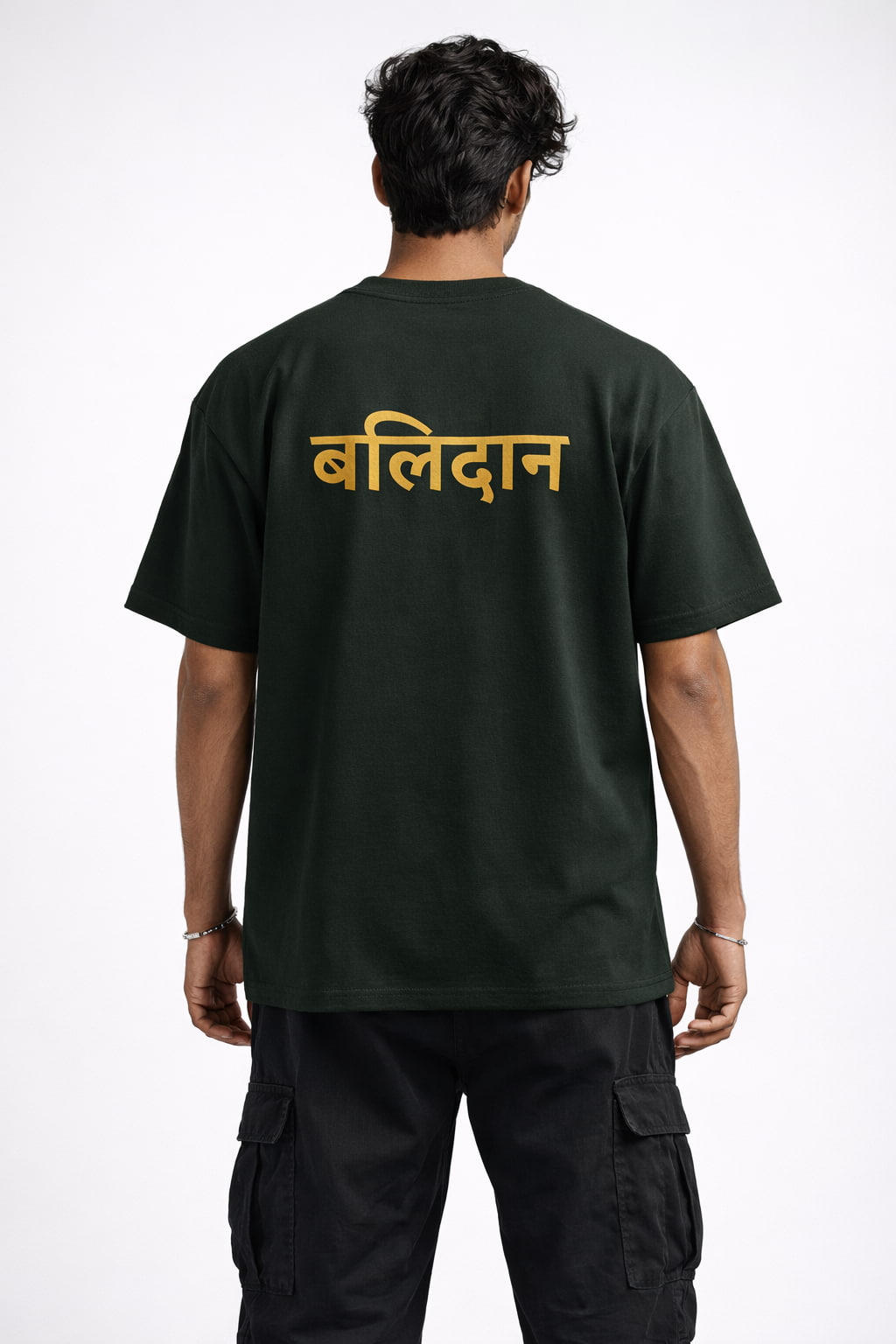 Person wearing a black t-shirt with gold text on the back against a white background