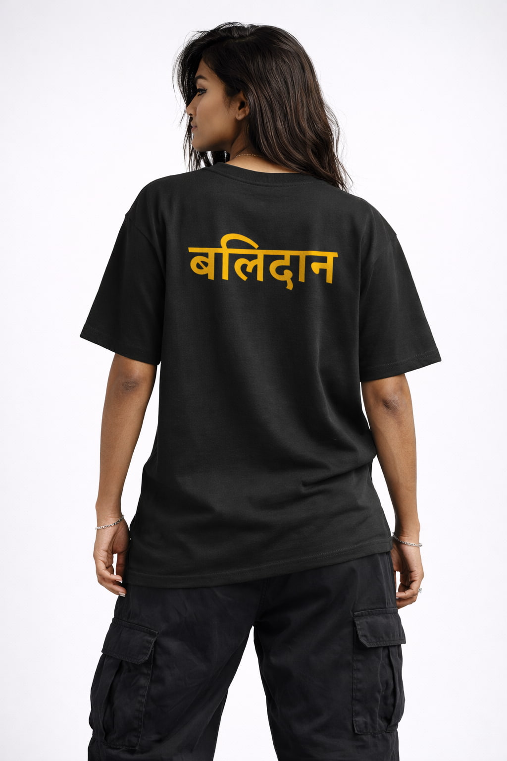 Person wearing a black t-shirt with yellow text on the back against a white background