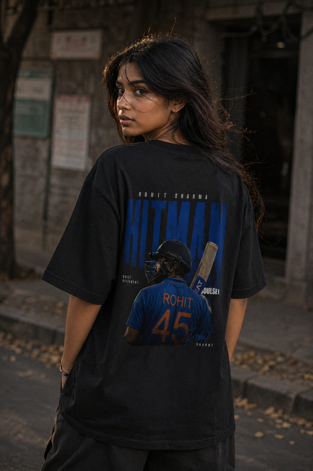 Person wearing a black t-shirt with a graphic design of a baseball player and text.