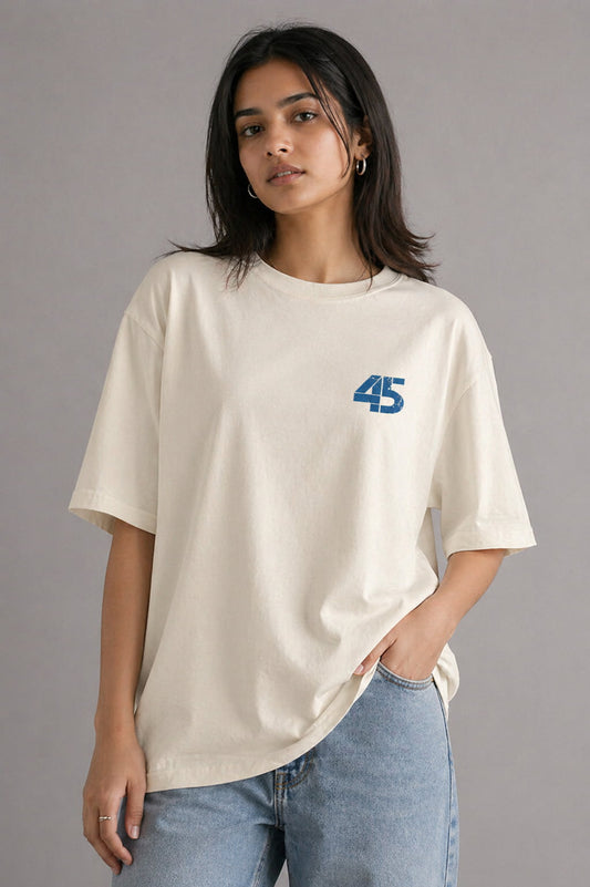 Person wearing a beige t-shirt with a blue number 45 design on a gray background