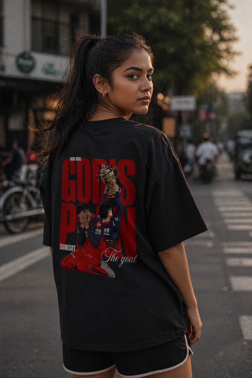 Woman wearing a black t-shirt with graphic design on a street