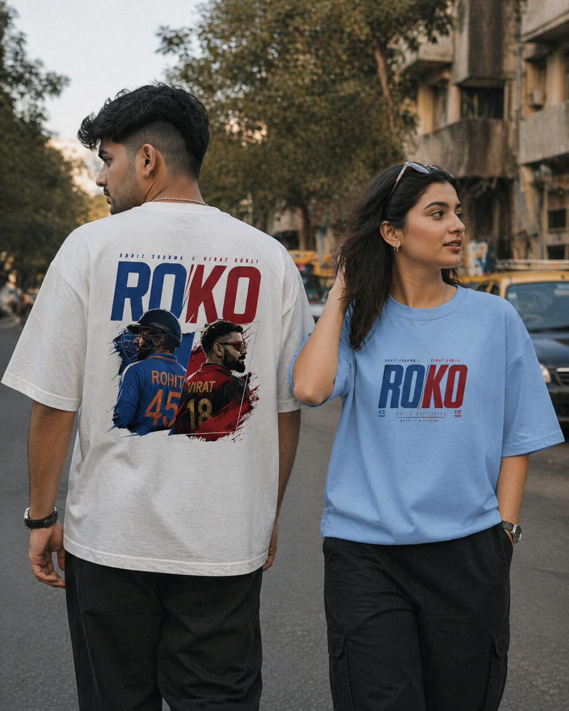 Two people wearing t-shirts with 'ROKO' branding on a street.