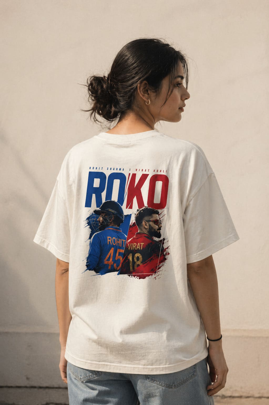 Person wearing a white t-shirt with a graphic design and text on the back.