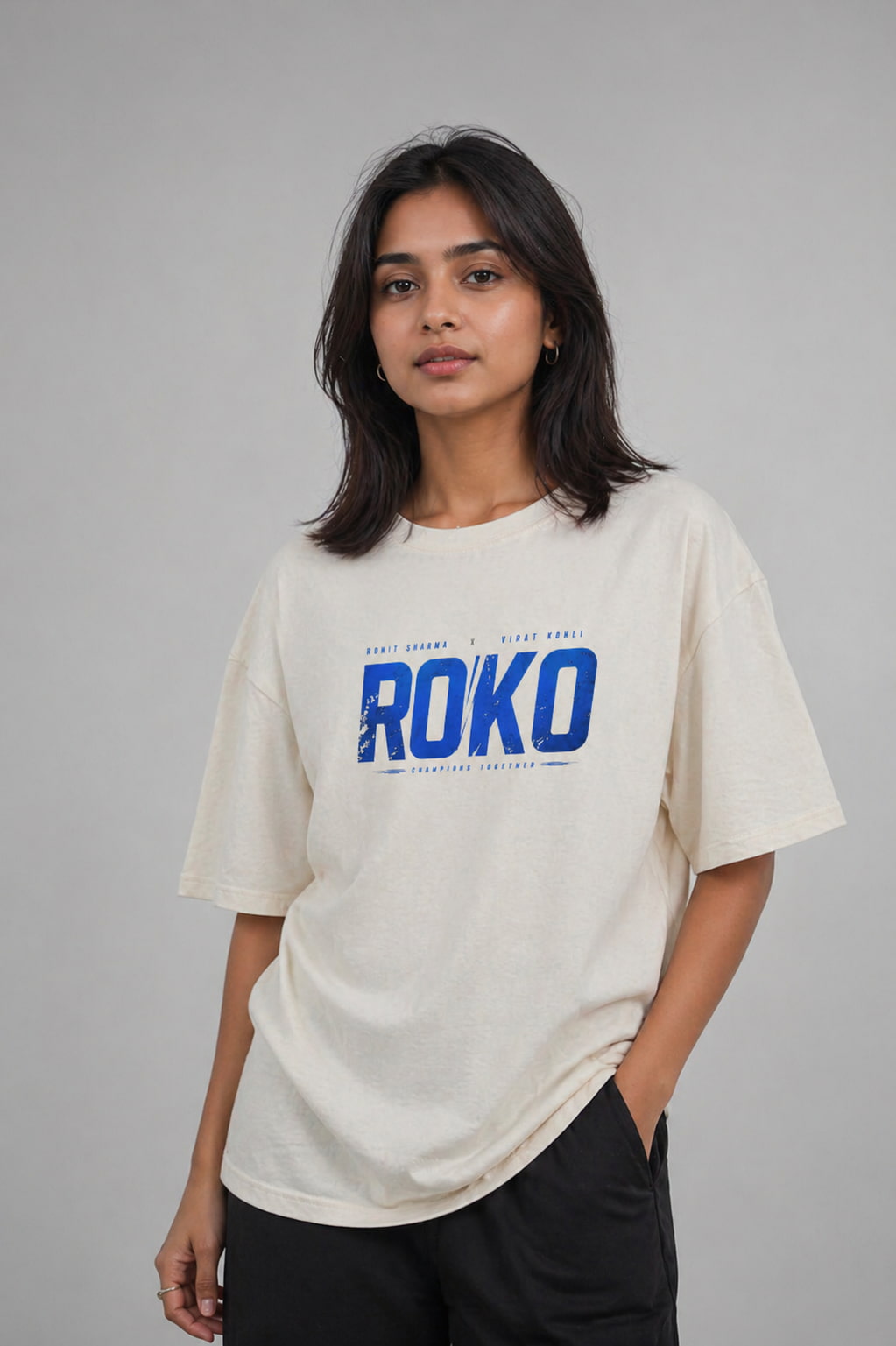 Person wearing a white t-shirt with 'ROKO' logo on a gray background