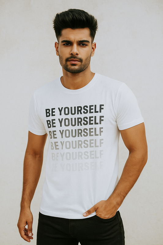 Man wearing a white t-shirt with 'BE YOURSELF' text on a plain background