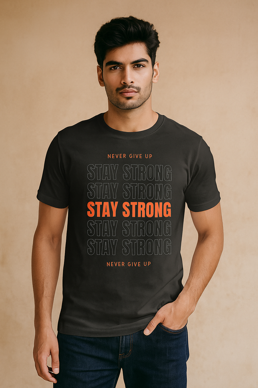 Man wearing a black t-shirt with motivational text on a beige background STAY STRONG