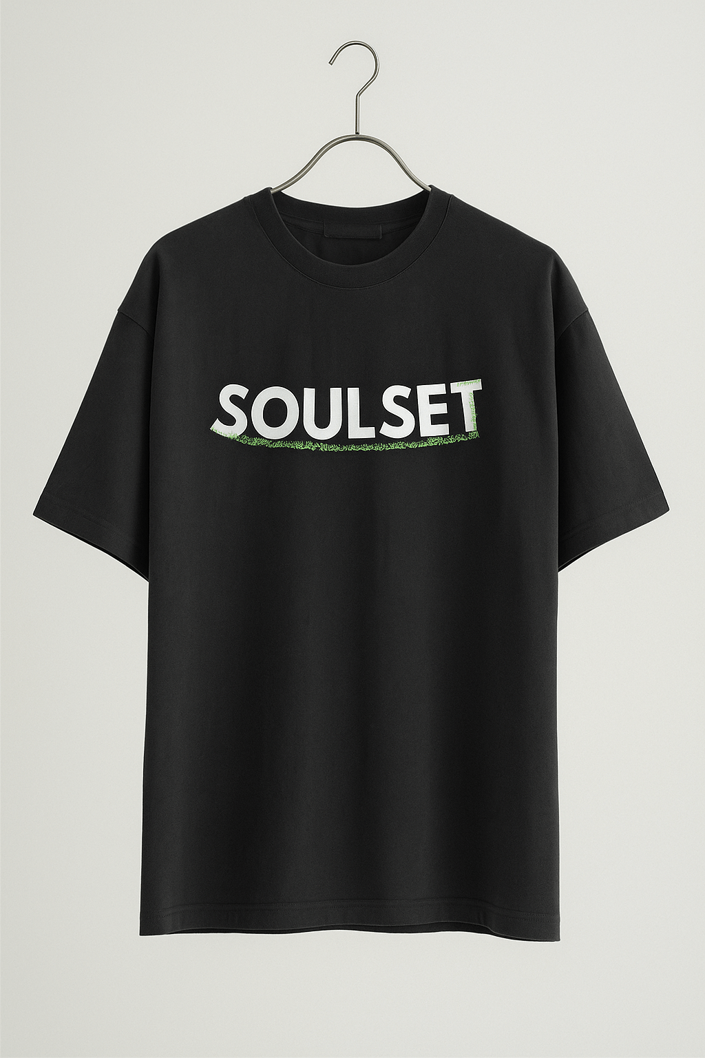 Black oversized SoulSet T-shirt on hanger with centered white "SOULSET" text and green underline, photographed for online clothing store.