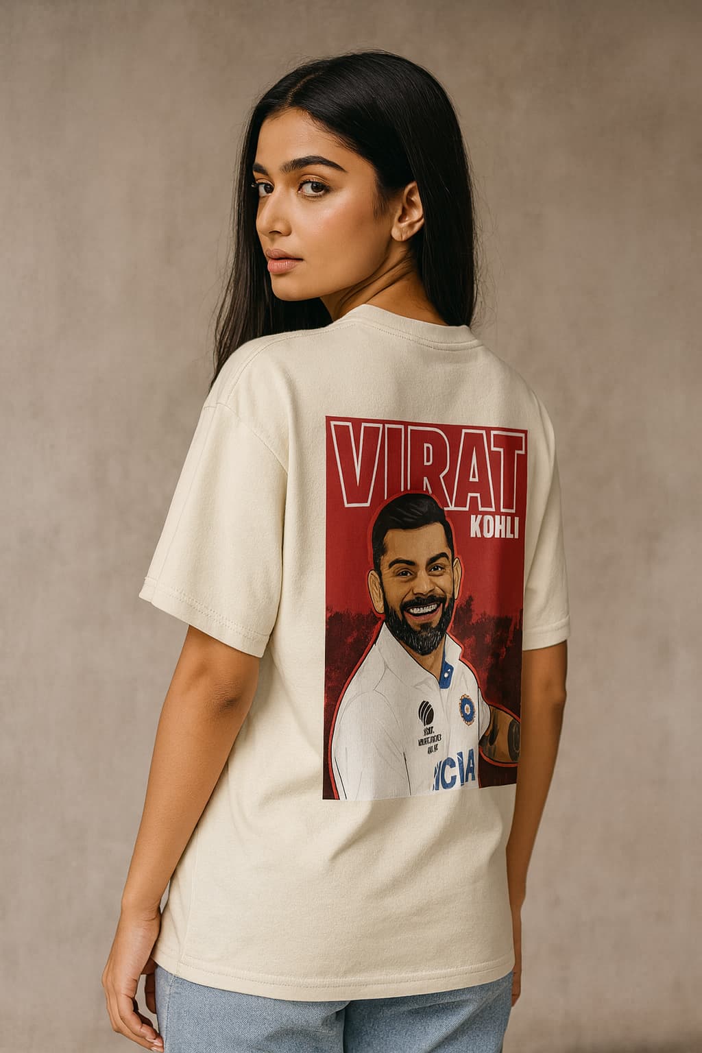 Person wearing a t-shirt with a printed design and text on a plain background