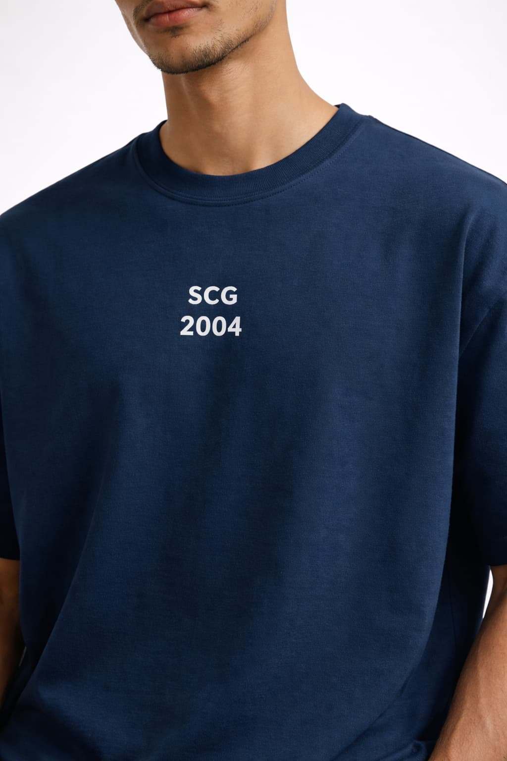 Person wearing a navy blue t-shirt with 'SCG 2004' text on a white background