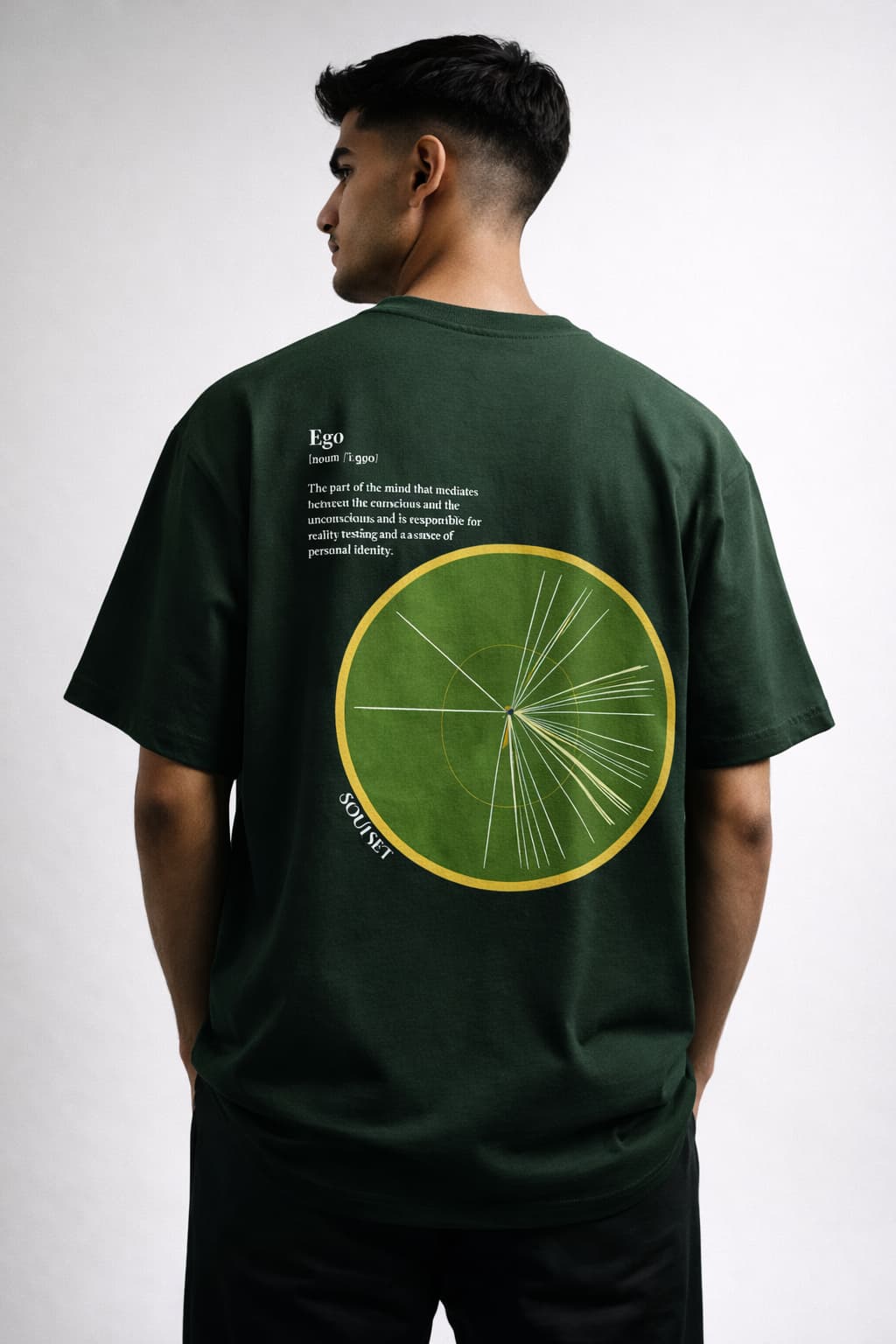 Person wearing a green t-shirt with a circular design on the back against a white background