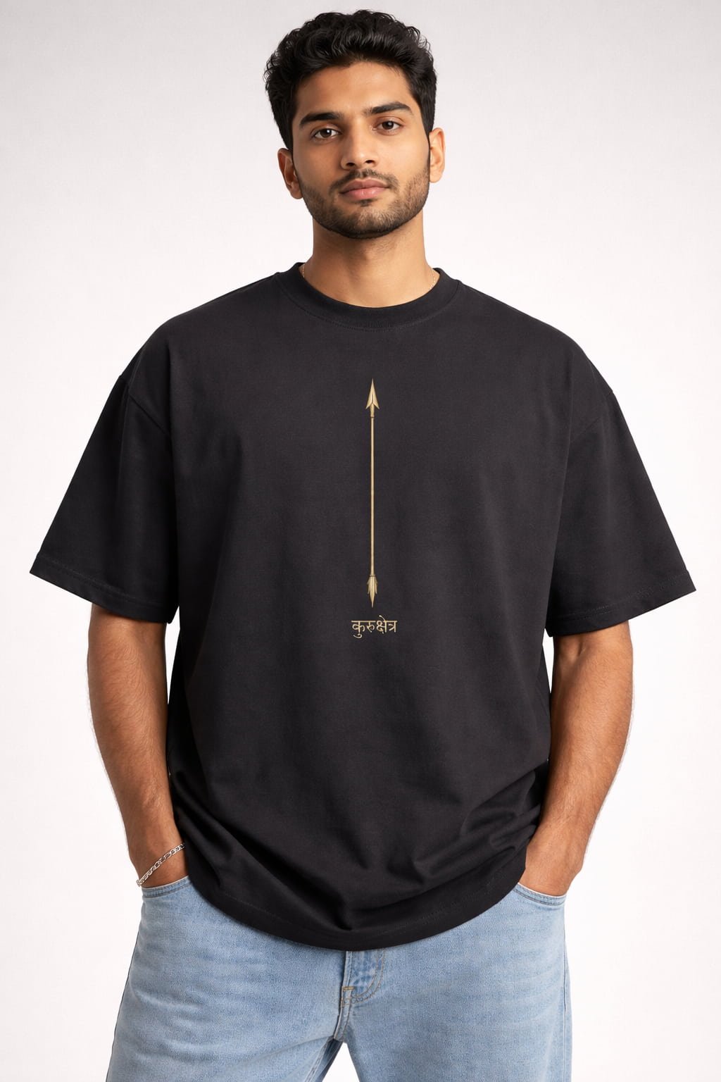 Man wearing a black t-shirt with an arrow design on a plain background