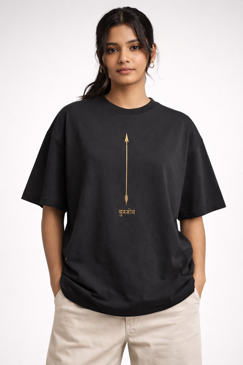 Person wearing a black t-shirt with a gold design on a white background