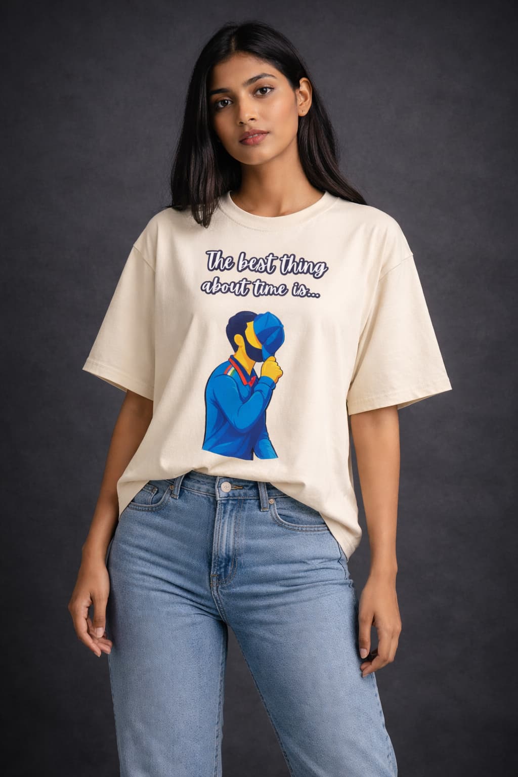 Person wearing a white t-shirt with a graphic and text, standing against a dark background