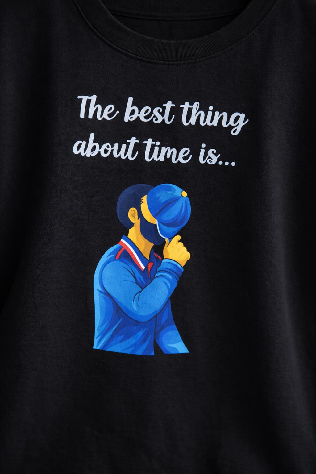Black t-shirt with a graphic of a person wearing a blue cap and text 'The best thing about time is...' on a black background.