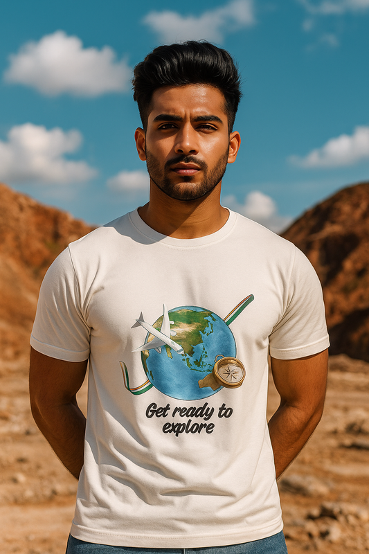 Man wearing a white t-shirt with a graphic design and text, standing in a desert landscape.