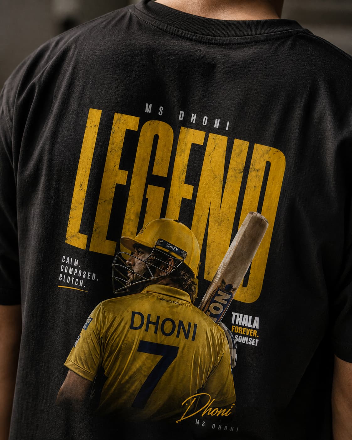 Black t-shirt with yellow text and graphic of a player, featuring the word 'Legend DHONI ' and the number 7.