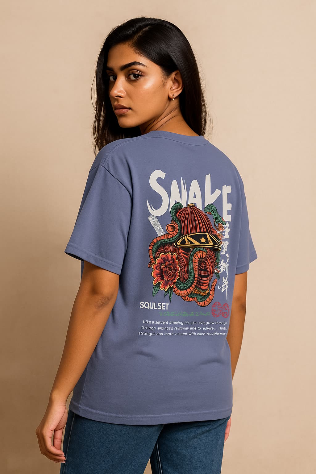 Person wearing a blue t-shirt with a colorful snake design and text on the back against a beige background