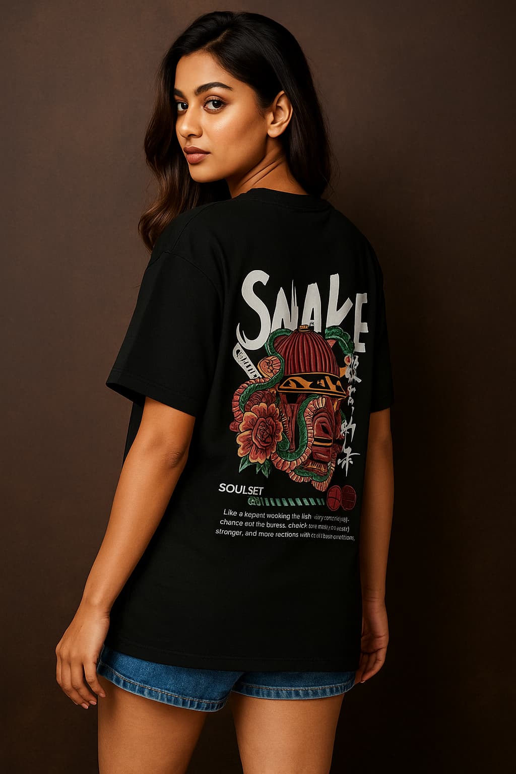 Woman wearing a black t-shirt with a colorful design and text on the back against a brown background