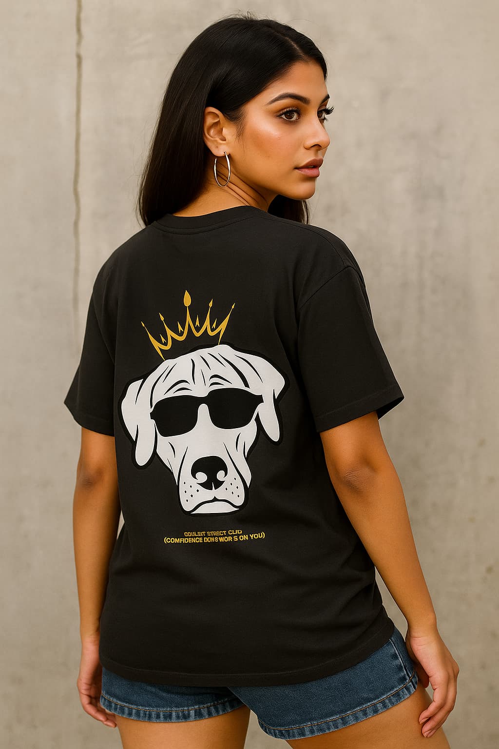 Person wearing a black t-shirt with a graphic of a dog wearing sunglasses and a crown on the back.