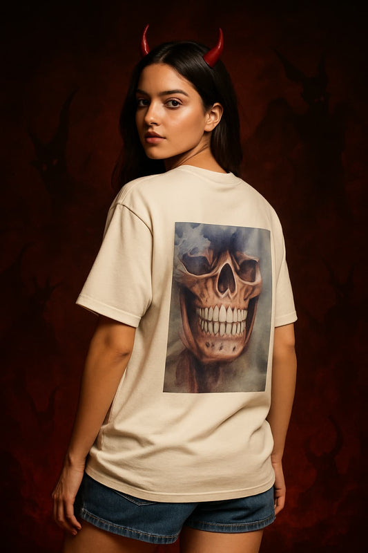 Person wearing a beige t-shirt with a skull graphic on a dark background