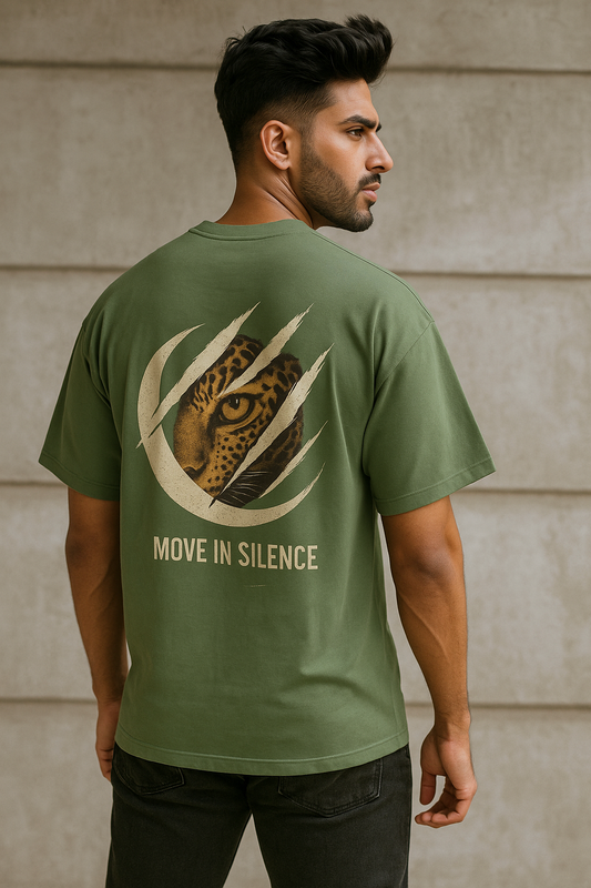 Man wearing a green t-shirt with a leopard design and text 'Move in Silence' on the back.