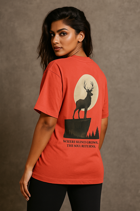 Woman wearing a red t-shirt with a deer graphic and text on the back against a brown background