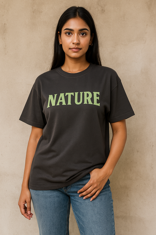 Person wearing a black t-shirt with 'NATURE' printed in green on a beige background
