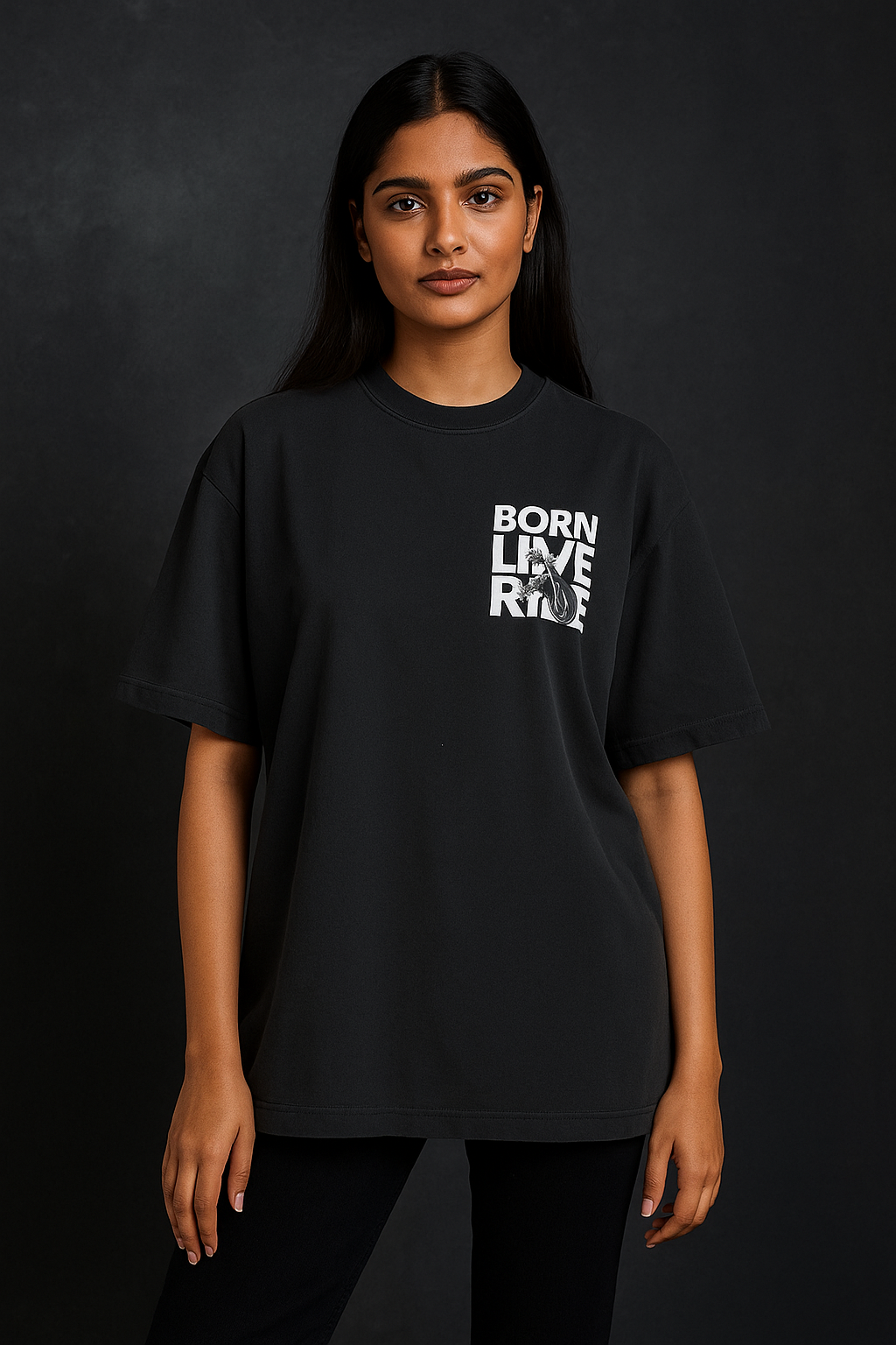 Person wearing a black t-shirt with 'BORN LIVE RIDE' text on a dark background
