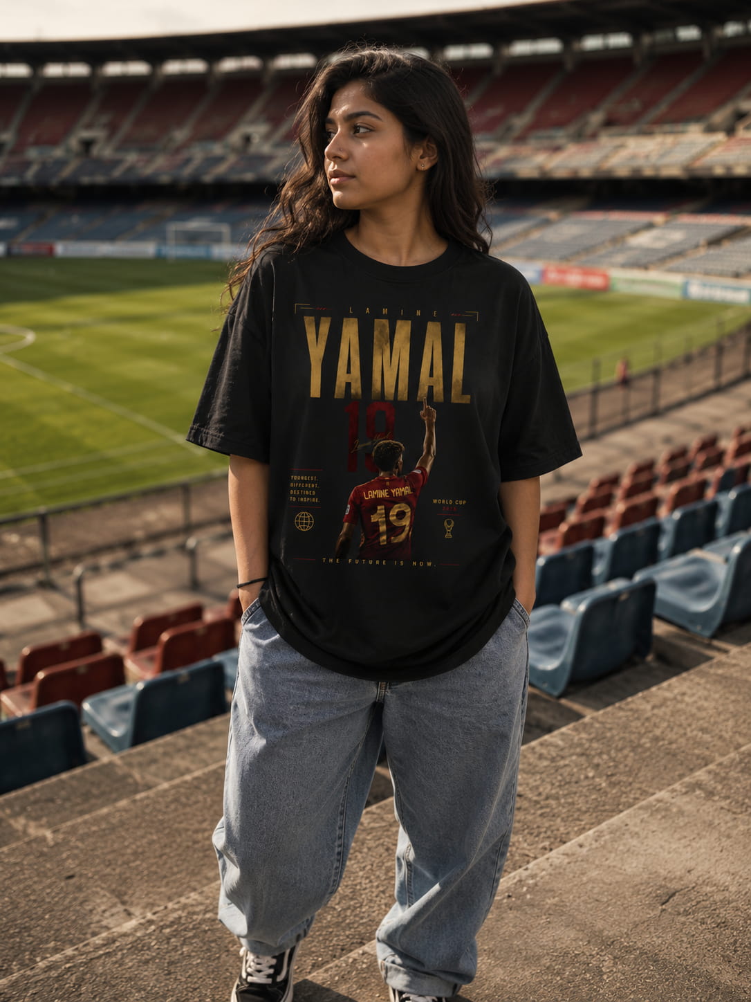 Person wearing a black t-shirt with 'YAMAL' text in a stadium setting