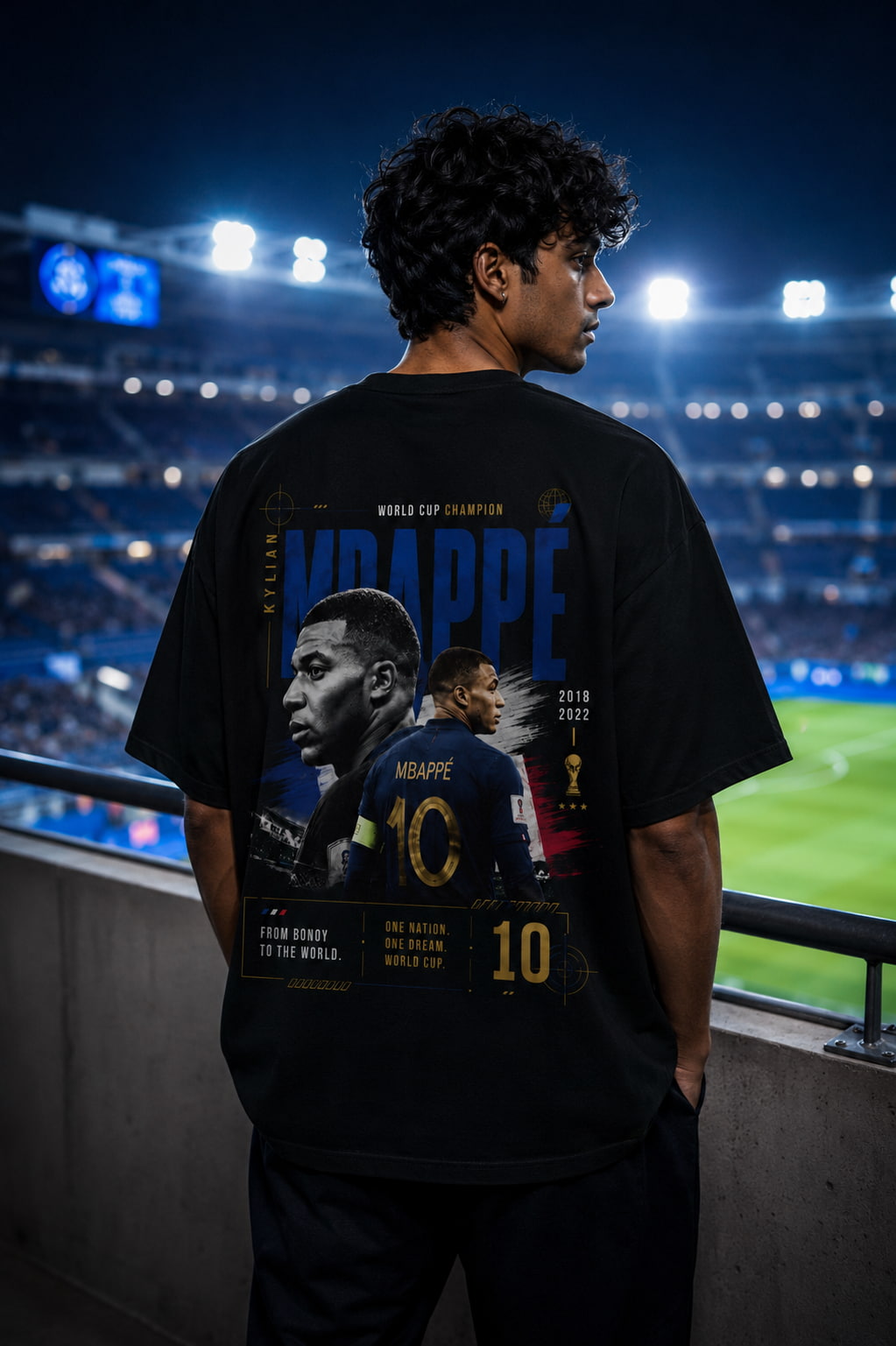 Person wearing a black t-shirt with a soccer player graphic and text in a stadium setting