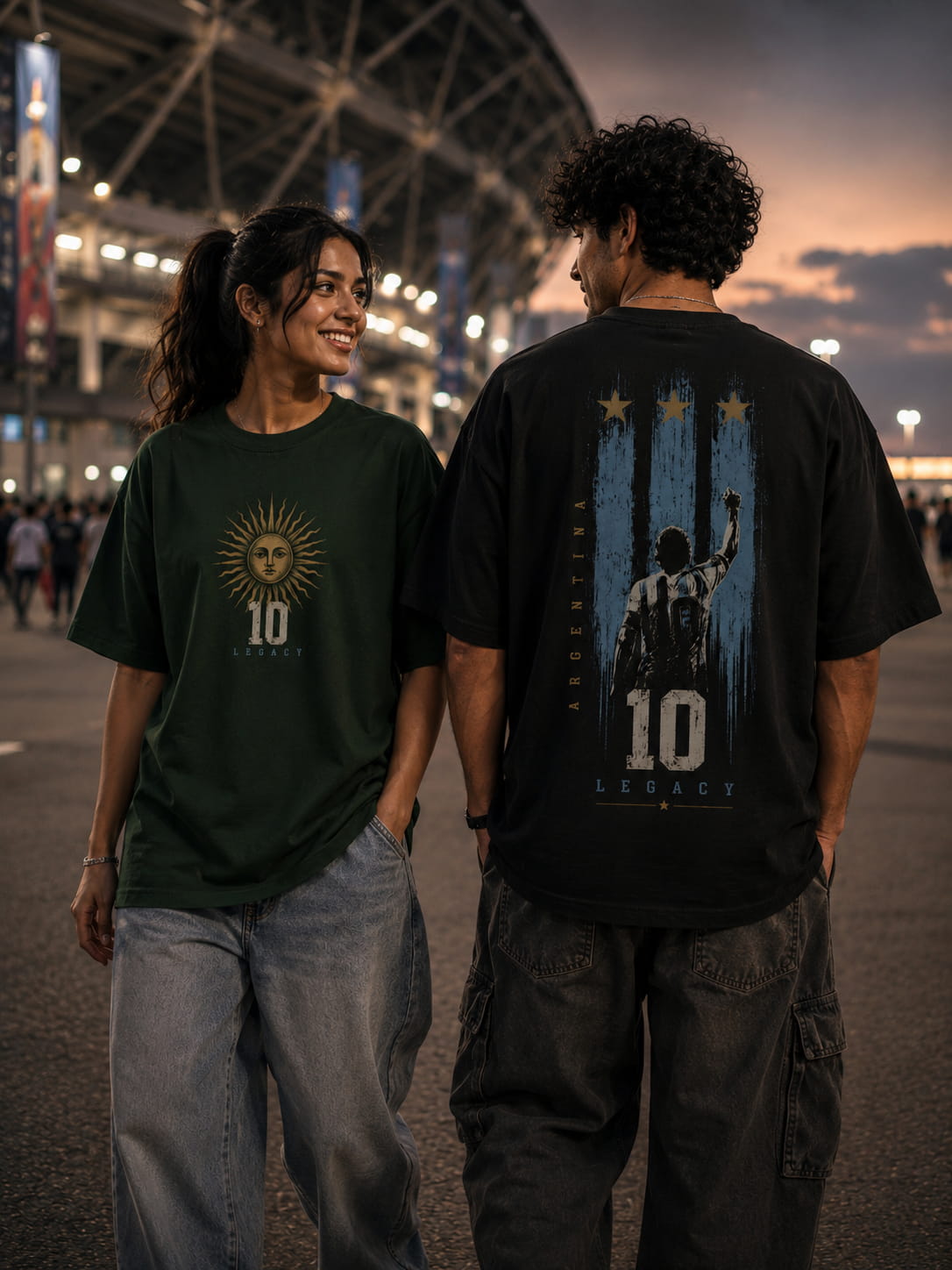 Two people wearing t-shirts with visible designs in an outdoor setting at night.